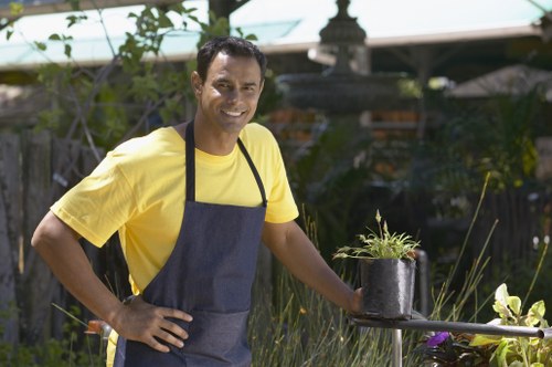 Professional gardeners Hanwell wearing PPE during garden maintenance
