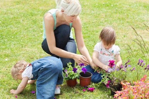 Professional gardeners in Hanwell improving a lawn and planting area